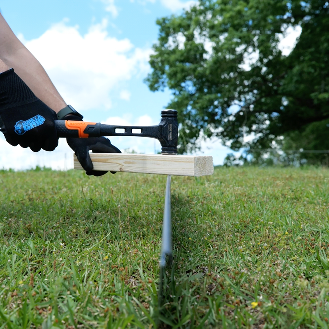 Installing CorTen landscape edging with Edge Right Installation Kit hammer and wood blocks.