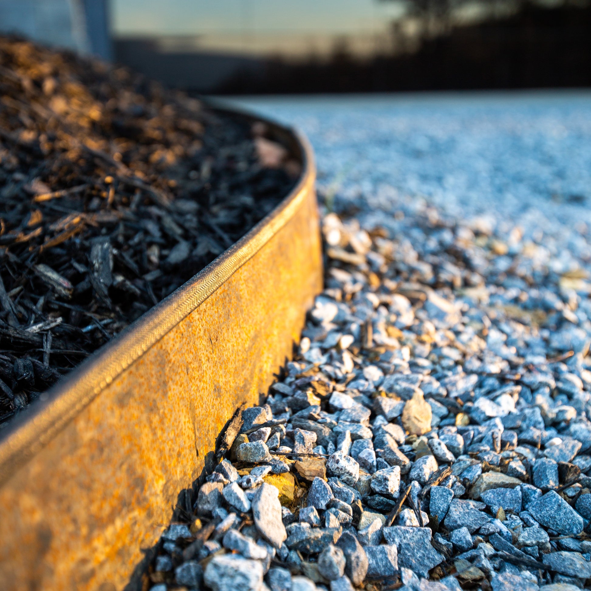 Edge Right's landscape edging along gravel driveway. Installed with protective edge guard.