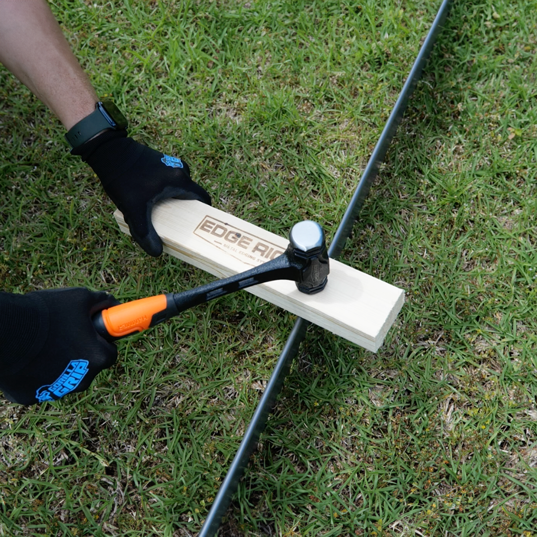 Hammering CorTen landscape edging using Edge Right Installation Kit hammer and wood block.