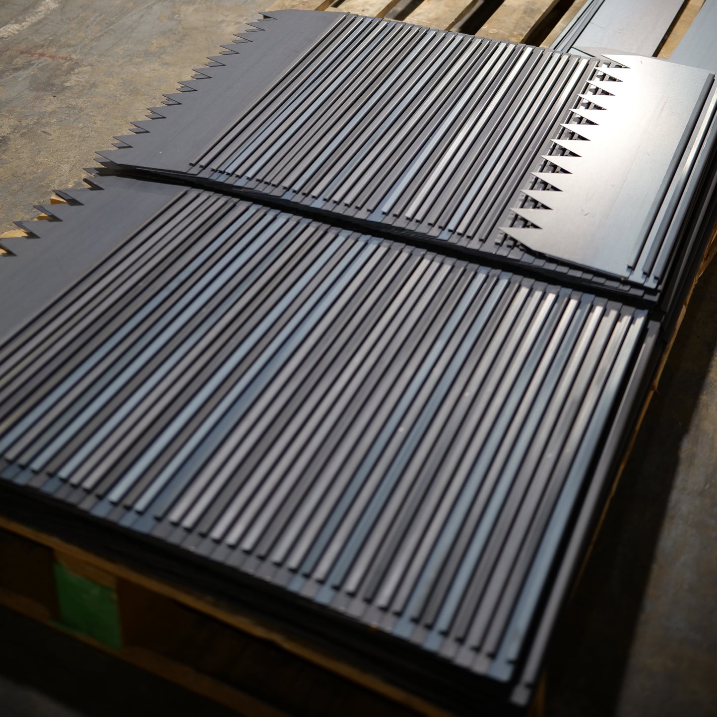Stacked 2ft long rolled COR-TEN steel landscape edging strips with on pallet