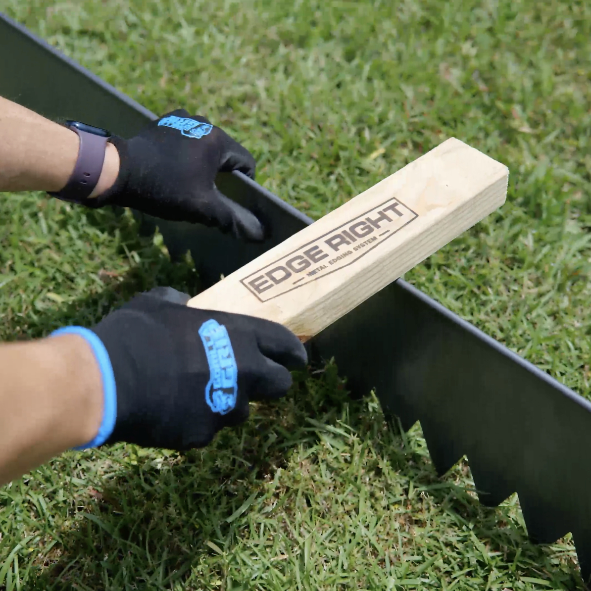 Placing CorTen edging with bottom serrated teeth using EDGE RIGHT wood installation block.