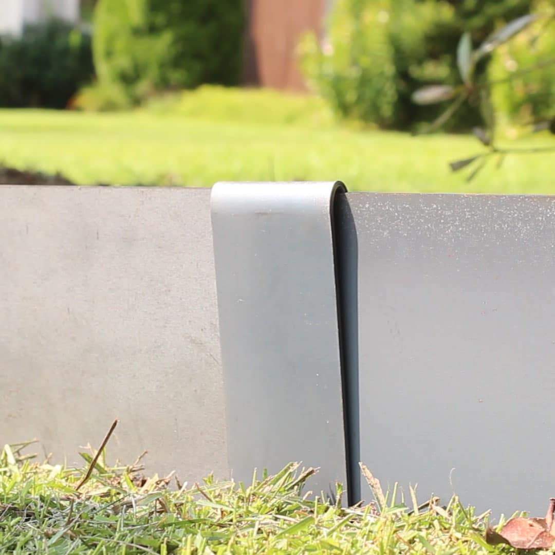 Up close image of the corten steel connecting clamp that is used to connect corten steel strips of landscape edging together. 